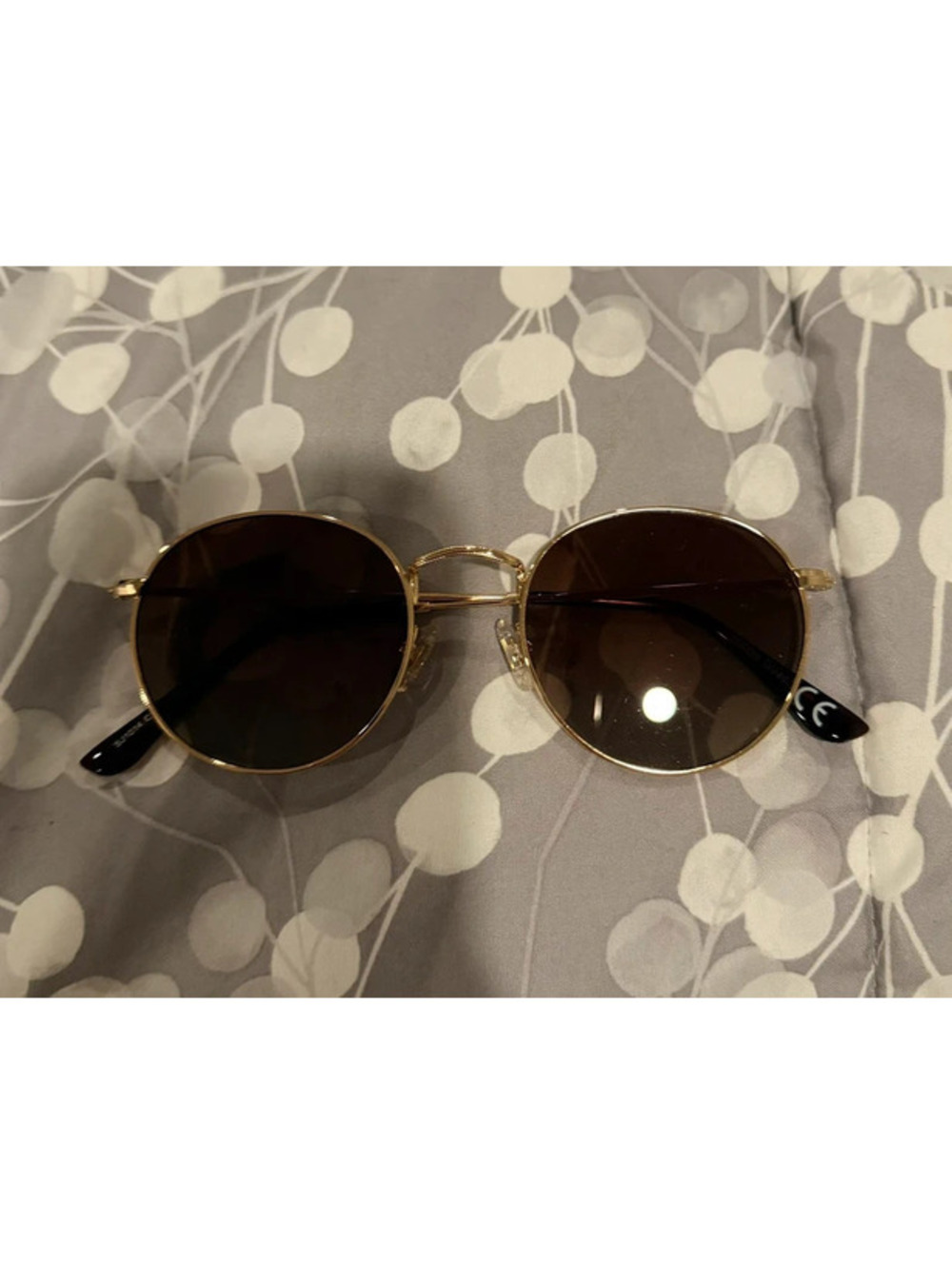 Round gold sunglasses with brown lenses